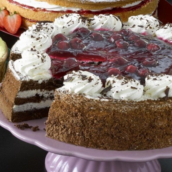 Chocolate Cake Coated In Cream and Cherries