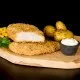 Southern Fried Chicken on a serving platter with potatoes, sauce, and corn