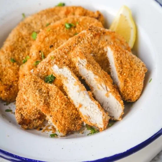 Southern Fried Chicken on a serving platter with potatoes, sauce, and corn