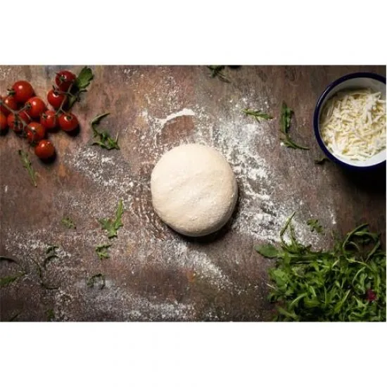 A ball of pizza dough on a floured counter