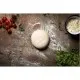 A ball of pizza dough on a floured counter