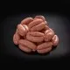 Cocktail Sausages on a Square Plate with a Side of Salad and Mustard