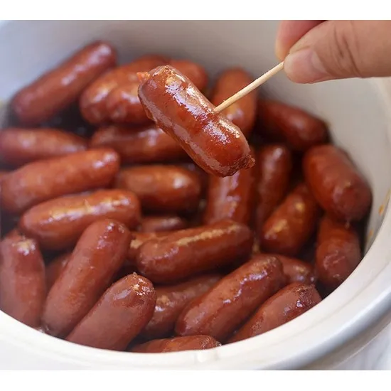Cocktail Sausages on a Square Plate with a Side of Salad and Mustard