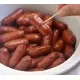 Cocktail Sausages on a Square Plate with a Side of Salad and Mustard