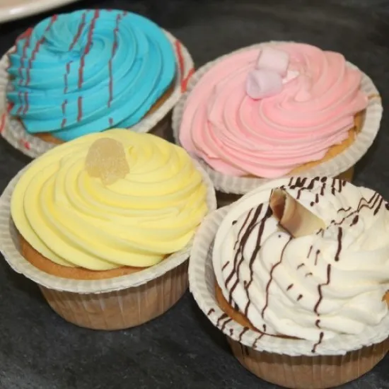 Four multicoloured individually iced cupcakes